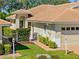 Lovely home with a terra cotta roof and manicured landscaping at 1117 Topelis Dr, Englewood, FL 34223