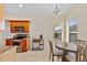 Bright eat-in kitchen featuring wood cabinetry, granite countertops, and stainless steel appliances at 1117 Topelis Dr, Englewood, FL 34223