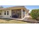 Exterior view of the home with a screened lanai, manicured lawn, and convenient paver walkway to the side yard at 1117 Topelis Dr, Englewood, FL 34223