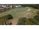 Aerial view of golf course with sand traps, water features, and homes at 1207 Highland Greens Dr, Venice, FL 34285