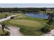 Aerial view of golf course with putting green and water features at 1207 Highland Greens Dr, Venice, FL 34285