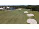 Aerial view of golf course with sand traps, water features, and homes at 1207 Highland Greens Dr, Venice, FL 34285