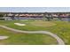 Aerial view of golf course with sand traps, water features, and homes at 1207 Highland Greens Dr, Venice, FL 34285