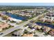 Aerial view of a community featuring many houses and waterways at 1207 Highland Greens Dr, Venice, FL 34285