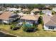 Aerial view of house with pool and canal at 1207 Highland Greens Dr, Venice, FL 34285