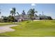 Community clubhouse with palm trees at 1207 Highland Greens Dr, Venice, FL 34285