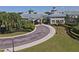 Landscaped Clubhouse entrance with driveway at 1207 Highland Greens Dr, Venice, FL 34285