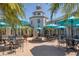 Relaxing community courtyard with fountain, shaded seating, and umbrellas at 1207 Highland Greens Dr, Venice, FL 34285