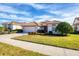 Single-story house with a tan roof, white walls, and a two-car garage at 1207 Highland Greens Dr, Venice, FL 34285