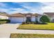 Single story house with a tile roof, white walls, and a two car garage at 1207 Highland Greens Dr, Venice, FL 34285