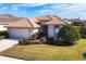 Single-story house with a tile roof, light-colored exterior, and landscaping at 1207 Highland Greens Dr, Venice, FL 34285