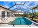 Sparkling screened pool with patio furniture and lake view at 1207 Highland Greens Dr, Venice, FL 34285