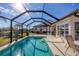 Relaxing screened pool with patio furniture and lake view at 1207 Highland Greens Dr, Venice, FL 34285