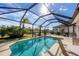 Beautiful screened pool with patio furniture and lake view at 1207 Highland Greens Dr, Venice, FL 34285