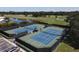 Two well-maintained tennis courts with seating at 1207 Highland Greens Dr, Venice, FL 34285