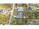 Aerial view shows a well-maintained lawn, surrounding trees and neighborhood at 1230 Gantry Rd, North Port, FL 34288