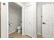 Bathroom featuring toilet in separate area with tile floors and white doors at 1230 Gantry Rd, North Port, FL 34288