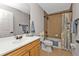 Bathroom featuring tub/shower combo with tile surround, single vanity, and neutral paint at 1230 Gantry Rd, North Port, FL 34288