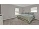 Bedroom with two windows, carpet flooring, and neutral paint at 1230 Gantry Rd, North Port, FL 34288