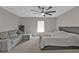 Spacious bedroom with carpet, fan, windows, and neutral paint at 1230 Gantry Rd, North Port, FL 34288