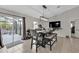 Dining room with modern light fixture, sliding doors to patio, tile floor, and dining set at 1230 Gantry Rd, North Port, FL 34288