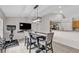 Dining room with TV, modern light fixture, tile floor, and view into kitchen at 1230 Gantry Rd, North Port, FL 34288