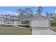 Well-maintained single-Gathering home featuring a two-car garage, landscaped front yard, and inviting entryway at 1230 Gantry Rd, North Port, FL 34288