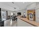 Open concept kitchen featuring stainless steel appliances, a breakfast bar, and an adjacent dining area at 1230 Gantry Rd, North Port, FL 34288