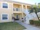 Two-story condo with white railing, lush landscaping and palm tree at 1235 Saxony Cir # 5105, Punta Gorda, FL 33983