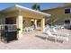 Outdoor grilling area with a clean grill and plenty of seating at 1235 Saxony Cir # 5105, Punta Gorda, FL 33983