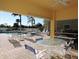 Poolside dining area with a ceiling fan, offering a relaxed and shaded space at 1235 Saxony Cir # 5105, Punta Gorda, FL 33983