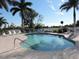 Enjoy this community pool area with a 3 ft depth, with surrounding palm trees and lounge chairs at 1235 Saxony Cir # 5105, Punta Gorda, FL 33983