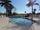 Community pool area features a 3 ft depth, surrounded by lush palm trees and plenty of seating at 1235 Saxony Cir # 5105, Punta Gorda, FL 33983