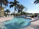 Community pool area features a 3 ft depth, surrounded by lush palm trees and plenty of seating at 1235 Saxony Cir # 5105, Punta Gorda, FL 33983