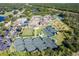 Aerial view of community with tennis courts, pool, and clubhouse at 13298 Scrub Jay Ct, Port Charlotte, FL 33953