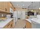 Kitchen with light wood cabinets and white appliances at 13298 Scrub Jay Ct, Port Charlotte, FL 33953