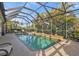 Refreshing swimming pool with screened enclosure and lush landscaping at 13298 Scrub Jay Ct, Port Charlotte, FL 33953