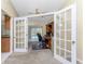 Home office with built-in desk and cabinets, and French doors leading outside at 157 Angol St, Punta Gorda, FL 33983