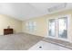 Bright and airy living room with carpeted floors, neutral walls, and French doors at 157 Angol St, Punta Gorda, FL 33983