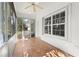 Screened porch with tiled floor, ceiling fan, and window at 1577 Red Oak Ln, Port Charlotte, FL 33948