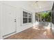 Bright screened porch with tiled floor, ceiling fan, and window at 1577 Red Oak Ln, Port Charlotte, FL 33948