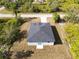 Aerial view of a single-story house with a gray roof and driveway at 158 Chickering St, Port Charlotte, FL 33954