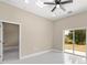 Bedroom with tile flooring, sliding glass doors, and access to backyard at 158 Chickering St, Port Charlotte, FL 33954