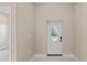 Bright and airy entryway with white door and tile flooring at 158 Chickering St, Port Charlotte, FL 33954