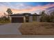 Newly constructed home with a modern exterior and driveway at 158 Chickering St, Port Charlotte, FL 33954