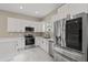 Modern kitchen with stainless steel appliances and white cabinets at 158 Chickering St, Port Charlotte, FL 33954