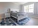 Bright bedroom with white bed frame and nautical-themed rug at 180 Hibiscus Dr # 112, Punta Gorda, FL 33950