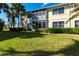 Building exterior showcasing landscaping and lawn at 180 Hibiscus Dr # 112, Punta Gorda, FL 33950