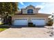 Two-car garage and inviting entryway with a brick paved driveway at 180 Hibiscus Dr # 112, Punta Gorda, FL 33950