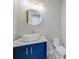 This bathroom has a white vessel sink, dark blue cabinetry, and a modern design at 183 Maria Ct, Punta Gorda, FL 33950